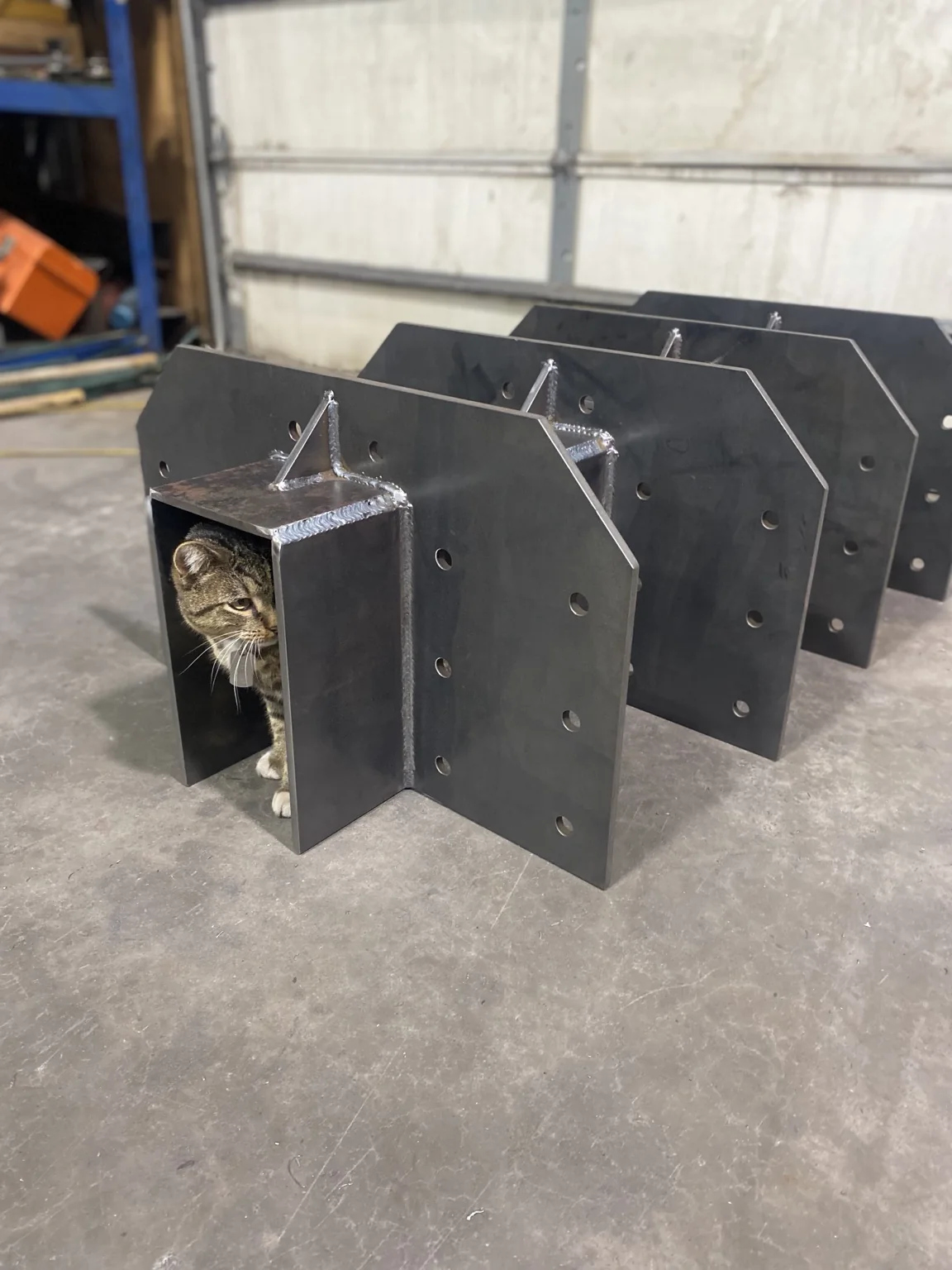 Three-eighth-inch plate brackets built to support W-beams for an ATV bridge